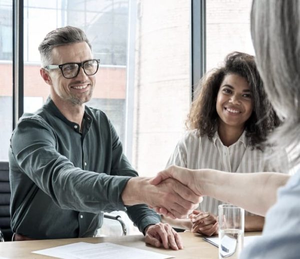 happy-businessman-and-businesswoman-shaking-hands